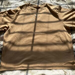 Nike essentials mini swoosh in hemp brown over side tee. Size M